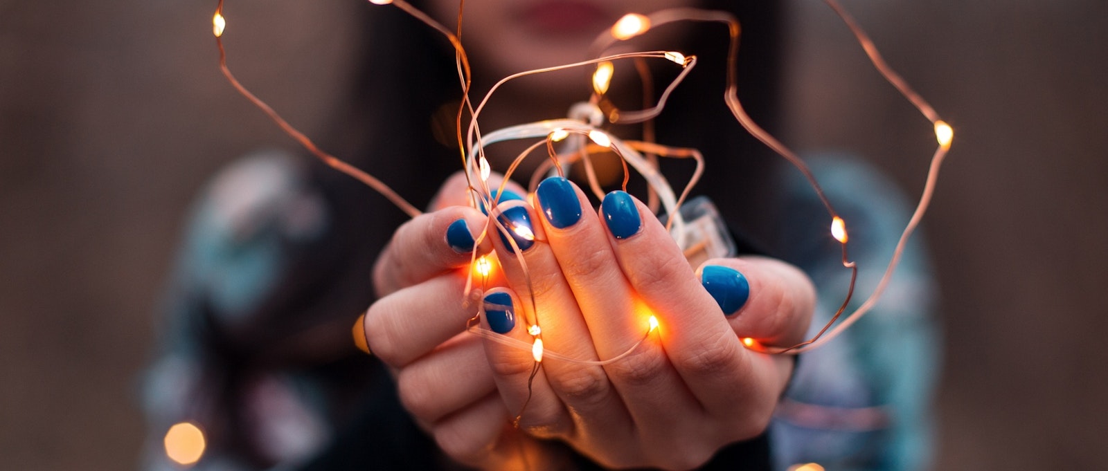 Woman holding fairy lights in hands