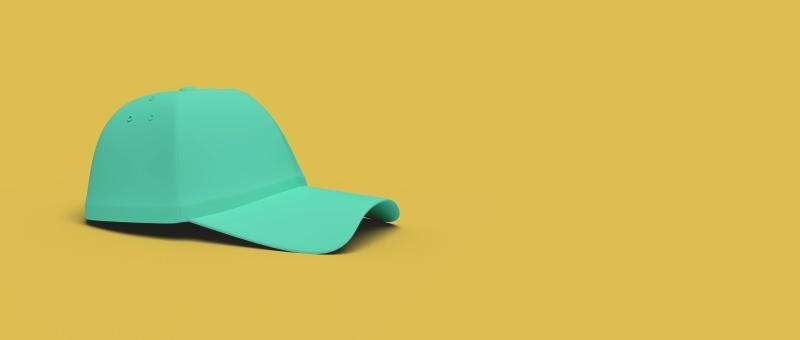 Green baseball cap against yellow background