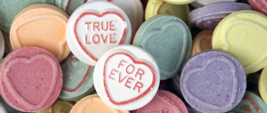 Iconic retro sweets with heart shape pattern and messages: True love, Forever.