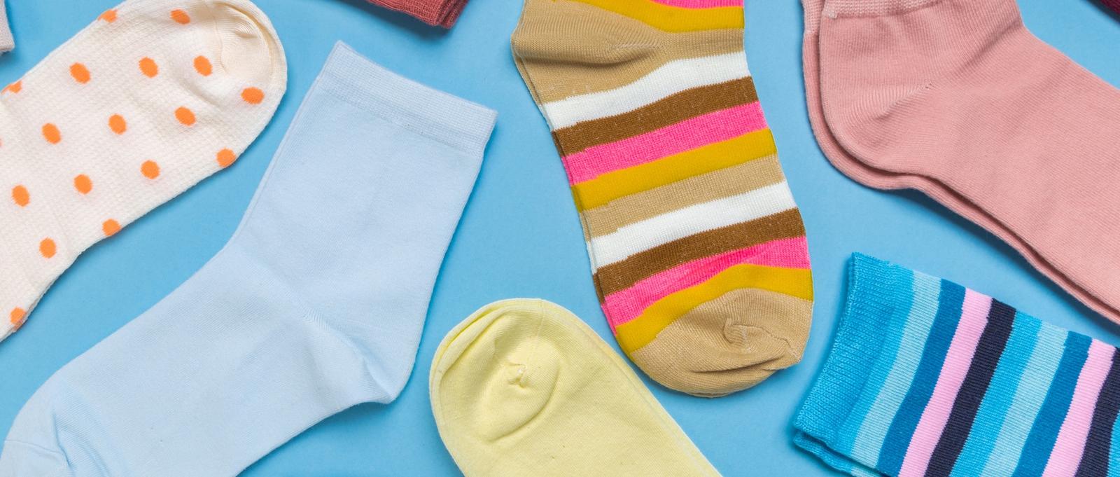 Multi-coloured socks on blue background.