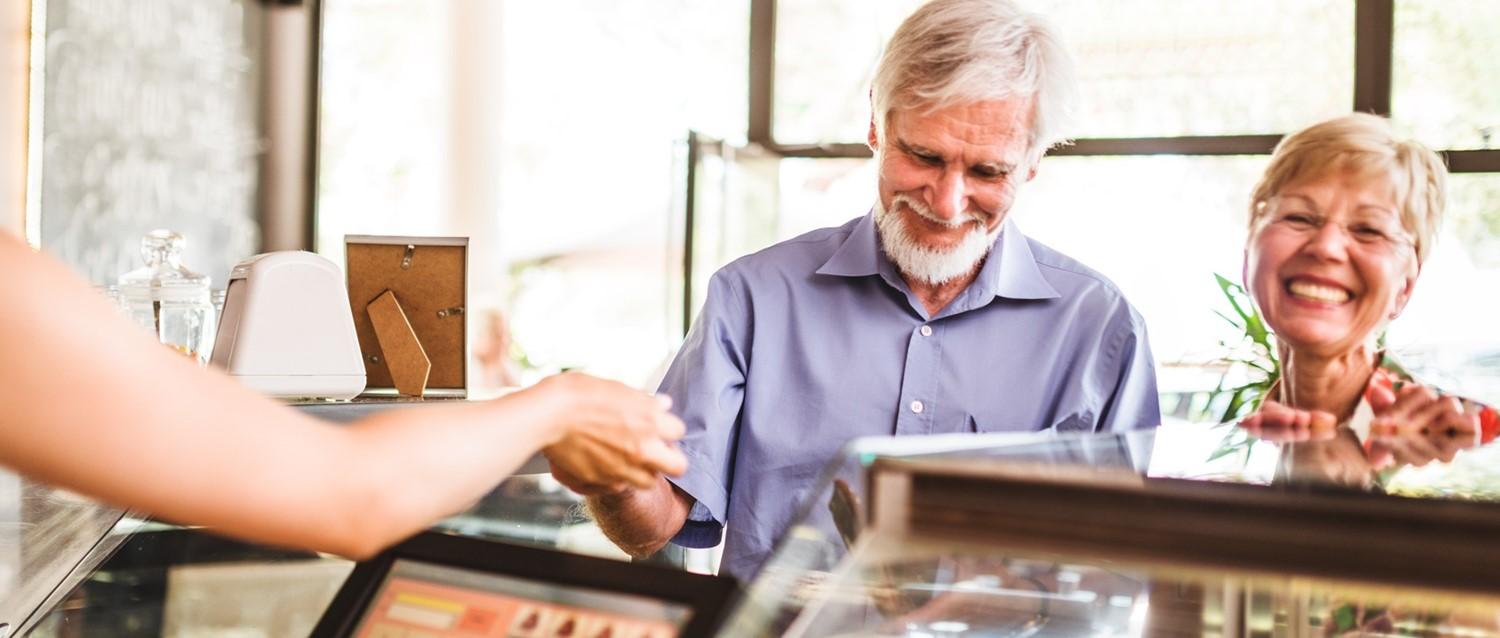 Old man paying at till