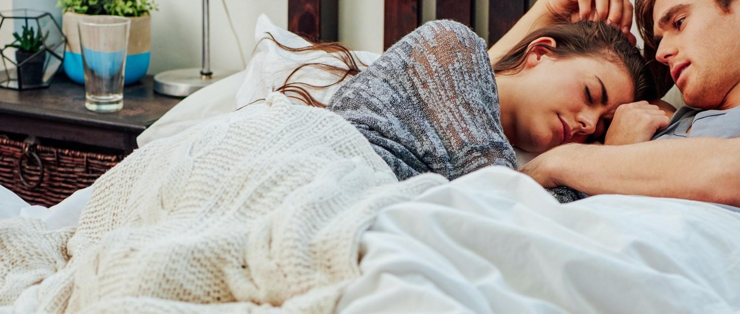 Sad couple in bed