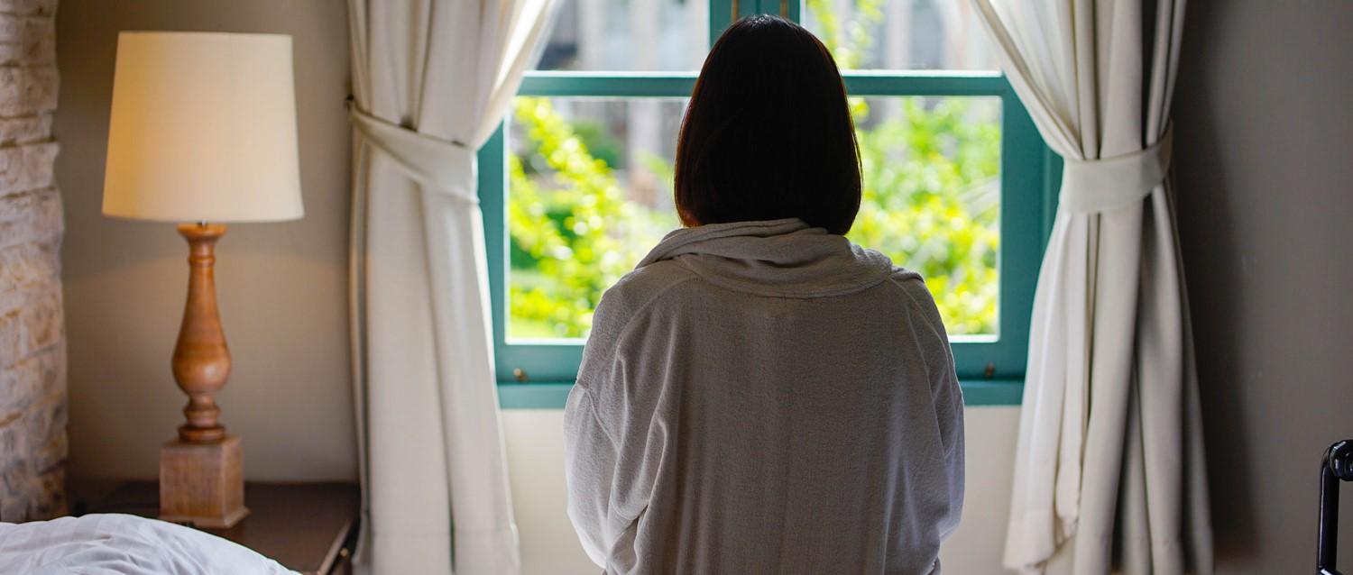 sad woman staring out of the window